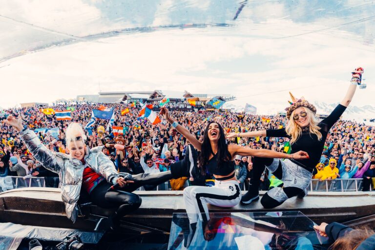 DJ Bjones engaging with the crowd at Tomorrowland, showing the iconic stage and colorful festival atmosphere